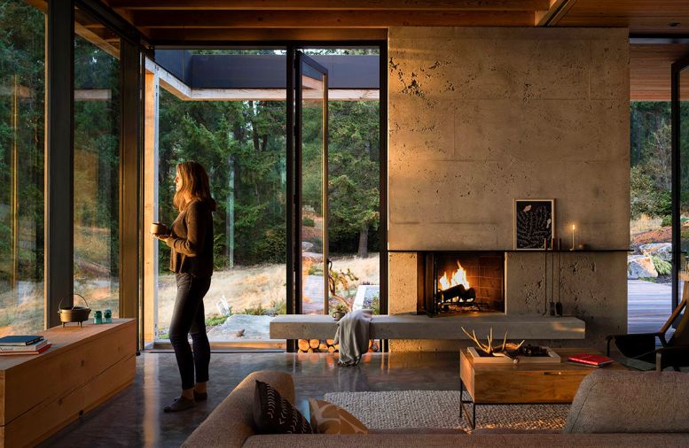 Tucked under the view windows, a salvaged pier beam has been cleverly reimagined as a discrete media station. A television can rise from the hollowed timber where it lives, tucked into the flooring and out of site.