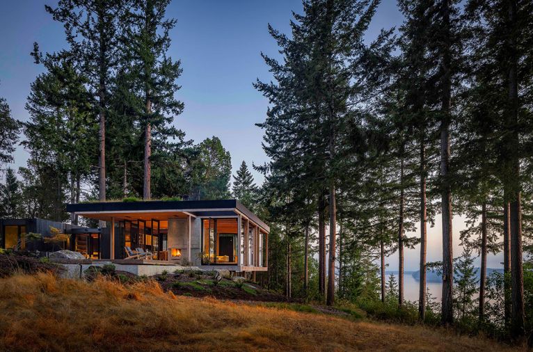 Local Western Red Cedar siding from Carl’s Building Supply has been painted a dark charcoal to minimize the visual impact of the highly textured wood. The powder-coated aluminum fascia from Miller Sheet Metal creates a framework for the green roof.