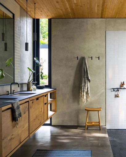Keeping with the ethos of cabinetry-as-furniture, Sparrow Woodworks’ custom oak cabinets also grace the bathroom. Crossville porcelain countertops from Creative Countertops. The poured concrete floors give way to a shower floor of Ann Sacks Salluto Mosaics tile in Nero.