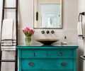 Karen found the antique teal dresser and Brian converted it to a sink console, the jumping-off point for the guest bathroom. The Robert Abbey Mini Chandelier from Chown Hardware and Los Jardine tile from Ann Sacks complete the bohemian vibe.