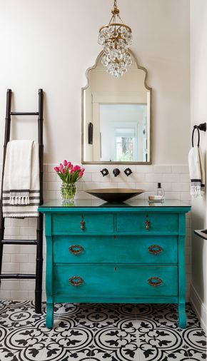 Karen found the antique teal dresser and Brian converted it to a sink console, the jumping-off point for the guest bathroom. The Robert Abbey Mini Chandelier from Chown Hardware and Los Jardine tile from Ann Sacks complete the bohemian vibe.
