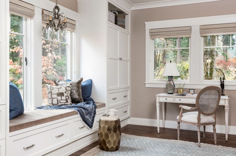 Karen Frank’s personal office and yoga room transforms into an additional guest bedroom via a convertible sofa bed. The additional cabinetry and window seat provide storage for exercise gear, linens, and guests’ needs. Custom cabinetry designed by Charla Ray Interior Design from Aura Cabinetry is in Benjamin Moore Swiss Coffee.