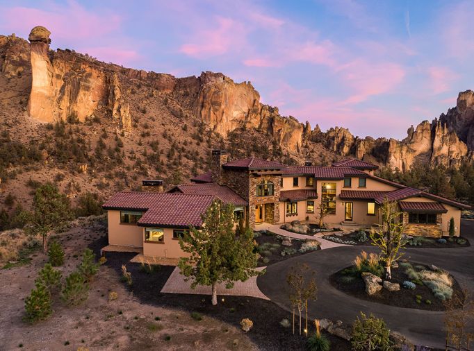 The exterior has Eagle concrete roof tiles with Tesla solar panels, Parex USA Stucco in the “Dry River” color, Cabinet Ridge Ledgestone used as accents, and aluminum-clad wood windows from Sierra Pacific. There are also Tesla wall batteries.