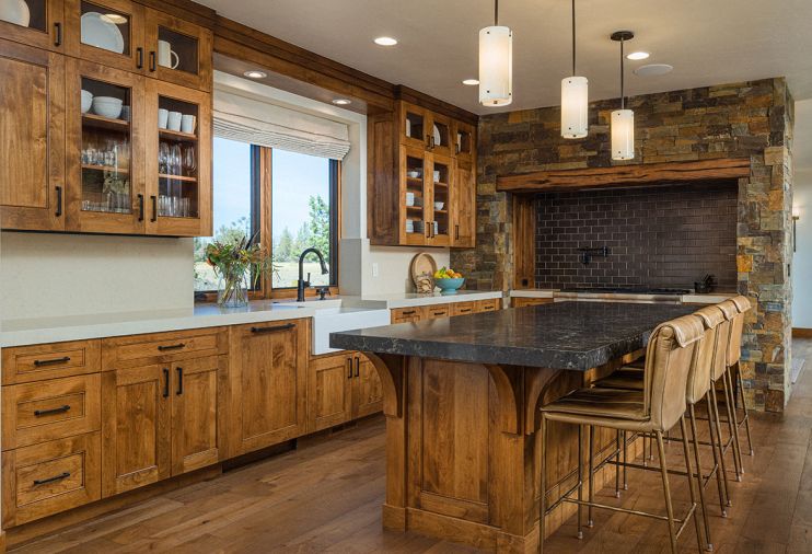 In the kitchen, the Superior Alder cabinetry is by Norman Wood Products, a division of Norman Building & Design, and topped with two different colors of polished Caesarstone.