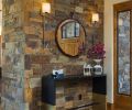 An accent wall in the entry has dry stack ledgestone.