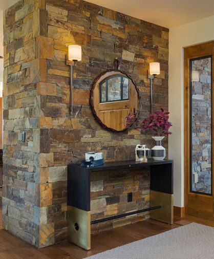 An accent wall in the entry has dry stack ledgestone.