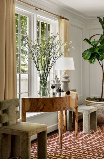 To add period panache to this corner of the living room, a pair of unique vintage chairs are reupholstered in Nancy Corzine fabric. New historic profile windows are flanked by Holland and Sherry draperies with Schumacher trim.