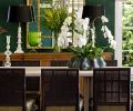 Maison, Inc. turns the homeowner’s passion for de Gournay wallcoverings into a breathtaking dining room. Here, a gold lattice mirror reflects multiple hand-painted peacocks, while a David Iastesta Weatherly Breakfront grounds the vignette. Finally, contrasting styles – modern Eos Chandelier with classic Karni bone inlay lamps – create take-your-breath-away beauty.