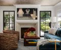 Maison, Inc. transformed a tiny smoking room into a family room warmed by a Francois and Co. fireplace with a shimmering Prato wallcovering ceiling by Nobilis from Kelly Forslund.