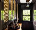 A former ugly duckling butler’s pantry now packs a sexy punch that invites bartenders to tarry awhile amidst the yummy surroundings. The solid walnut counter adds ballast to the lacquered cabinetry by Eddie Murphy Cabinets beneath showy Kardamyli Ceiling Lights.
