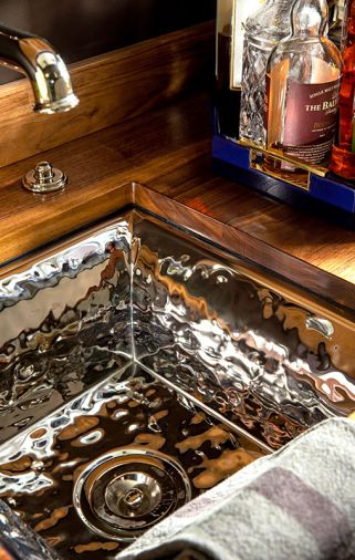 The Kallista hammered nickel bar sink from Ann Sacks adds additional glitter.