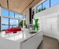 In the kitchen, the white lacquer cabinetry, Thermador appliances and hood insert, and Caesarstone Super White Quartz is all from Pedini NW. The ceiling has a custom recessed slot that allows flexibility in fixture aiming and location, designed by Dark Light Design.