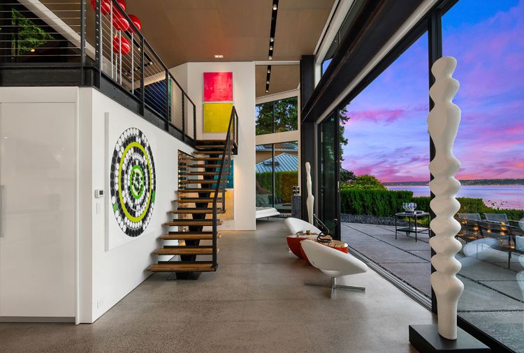The patio has cast-in-place concrete slab pavers surrounded by smaller pavers from Mutual Materials. “Opening up those sliding doors makes it so they’re able to basically live outside while they’re inside the house,” says architect Devin Johnson of Johnson Squared Architects.