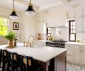 The kitchen has custom colored Floret VI Tile from Cement Tile Shop, custom flush inlay cabinets from Beechtree Woodworks, and a fir paneled island stained to match the wood elsewhere in the home.
