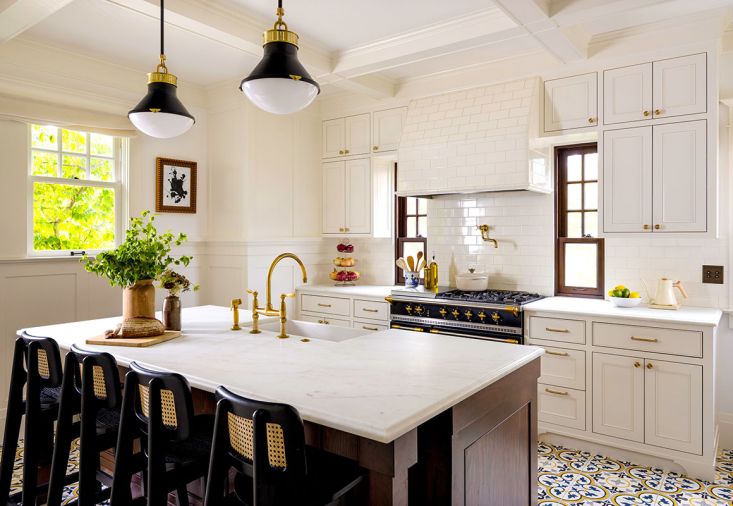 The kitchen has custom colored Floret VI Tile from Cement Tile Shop, custom flush inlay cabinets from Beechtree Woodworks, and a fir paneled island stained to match the wood elsewhere in the home.