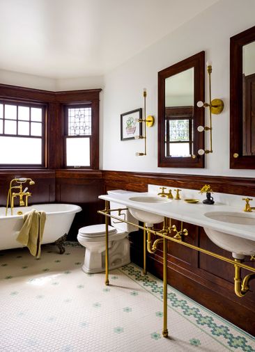 In the primary bathroom’s design was the perfect balance in maintaining the historical charm and using new products. The floor has custom hex mosaic with green details from Restoration Tile, a Cheviot clawfoot tub from Seattle Interiors, and custom brass vanity in a Victorian style from Palmer Industries.