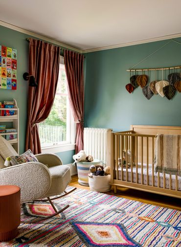 A child’s room has a jewel-toned palette and custom window treatments from Lesley Petty Studios.