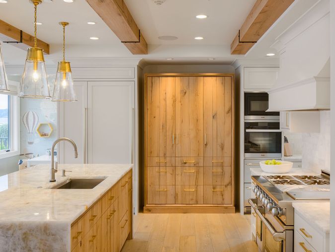 Crystallo Quartzite counters are lit by Visual Comfort Robinson Large Pendants. Appliances include Miele, Fisher & Paykel, Custom Caliber and True.