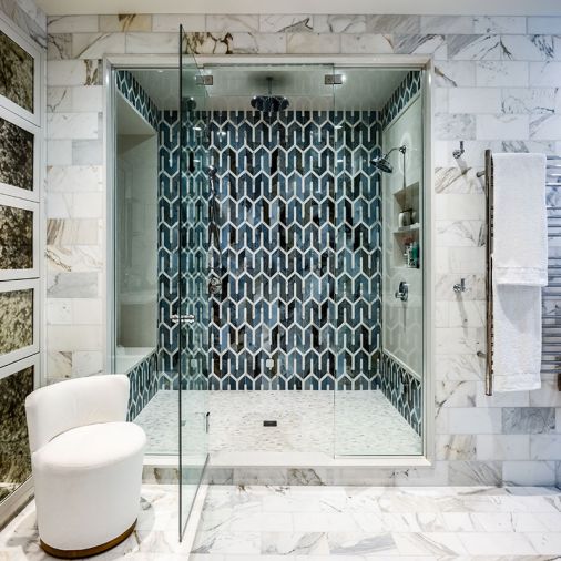 Ample walk-in shower features Ann Sacks Liberty Collection tile.
