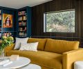 The Jake Sofa offers a pop of color in the library along with shelves painted in Benjamin Moore’s “Twilight”. The custom wood paneling and shelving by Smith Custom Woodworking create a comfortable space to read