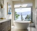 Hauser’s attention to detail and ability to create the right mood for every room extended to the spa-like vibe of the primary bath, with flooring by Statements Tile, an MTI tub with Brizo tub filler from Ferguson, and Avenue Lighting from Seattle Lighting