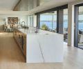 The steel moment frame is revealed off the relocated kitchen while Fleetwood sliders from Cherry Creek Windows & Doors opens to an extensive, yet welcoming deck.
