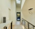 Light from the primary suite’s skylight brightens rift-cut white oak flooring.