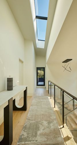 Light from the primary suite’s skylight brightens rift-cut white oak flooring.