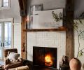 Guests can cozy up on a Manor Fine Wares armchair alongside the glistening Zellige Ann Sacks tiled fireplace, its mantel and surround crafted from wood felled on the property.