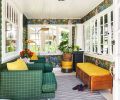 The sunroom with leafy green and golden rod colors accentuate its proximity to the lush garden. Monkeys happily populate the Savuti wallpaper; and the comfy Bernhardt chairs and Anthropology bench are in outdoor fabrics. The Rimini floor lamp illuminates via motion sensitive lighting.