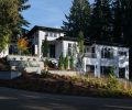 The exterior is painted in Sherwin Williams “Snowbound” with trim in “Tricorn Black,” and paired with white masonry accents. A black roof and ample windows create the rest of the look.