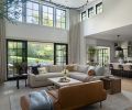 Four Hands side tables from J Garner Home flank the Restoration Hardware sectional. A leather sofa from Interior Define is an artful spot to lounge or seat guests.