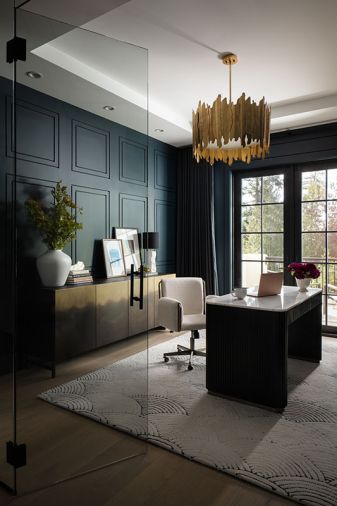 A Four Hands console from J Garner Home and Arhaus desk is set against the custom wall treatment and crowned with an Uttermost Golden Gate Wide Drum chandelier.