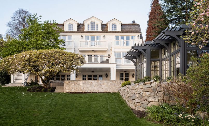 The backyard offers grand views of the home and the “Wellness Pavillion”, which houses an exercise room and golf simulator. Quantum and Loewen windows and doors throughout are from Windows, Doors & More.