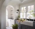 The pass-through pantry connects to the kitchen with custom marble tile flooring designed by Lawton and made by New Ravenna, complemented by a Black Mist Granite honed counter. Dual dishwashers flank the Shaws sink to make for a very pretty and very hardworking area.