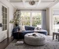 In the sitting room, the Lee Industries settee from J Garner Home has the best view of the water. Window coverings are from Lesley Petty Studios and the antique lamp above is from 1stDibs.