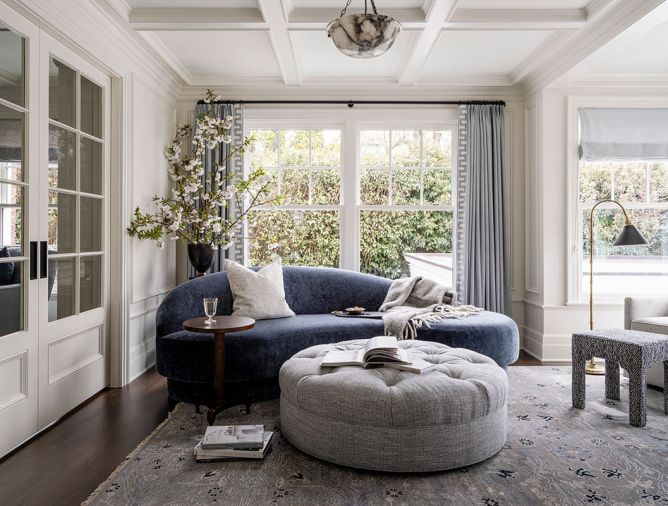 In the sitting room, the Lee Industries settee from J Garner Home has the best view of the water. Window coverings are from Lesley Petty Studios and the antique lamp above is from 1stDibs.