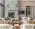 The Art Deco vibe is carried throughout the great room with bold Arhaus coffee tables flanked by Four Hands leather sofas and wall paneling to mirror the exterior siding.