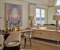 Marinello creates warmth, openness and sophisticated style in the décor by honoring the historical precedent found in classic furnishings by Gio Ponti and Saarinen and tying them to the homeowner’s collection of art, Sage Vaughan’s “Goners”. To help delineate the space, a custom credenza from Gauge Design Group was selected for added storage.