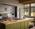 Taking cues from a vintage aesthetic, the kitchen feels collected rather than customized. Cabinets feature a variety of coordinated Benjamin Moore hues. Countertops are made of maple, black marble and zinc.