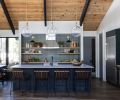 In the kitchen, the wooden shelving and cabinetry pops on “Chloe in Green” tile from Bedrosians. Caesarstone raw concrete counters from Imagine Stoneworks and stools from Denver Modern round out the room.