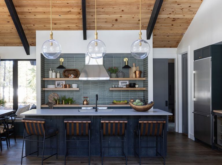 In the kitchen, the wooden shelving and cabinetry pops on “Chloe in Green” tile from Bedrosians. Caesarstone raw concrete counters from Imagine Stoneworks and stools from Denver Modern round out the room.