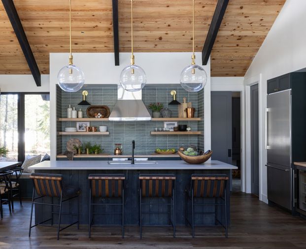 In the kitchen, the wooden shelving and cabinetry pops on “Chloe in Green” tile from Bedrosians. Caesarstone raw concrete counters from Imagine Stoneworks and stools from Denver Modern round out the room.