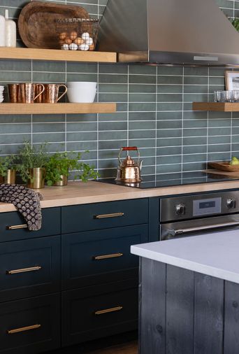The handsome cabinets are painted in “Studio Green” which are adorned with satin brass Kent Knurled pulls and knobs from Sumner Street Home Hardware.