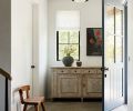 From the moment you step into the home upon aged limestone tile, simplicity reigns. An antique sideboard ties to a rare Artisans of Moralles 1950s cooperative handcrafted chair.