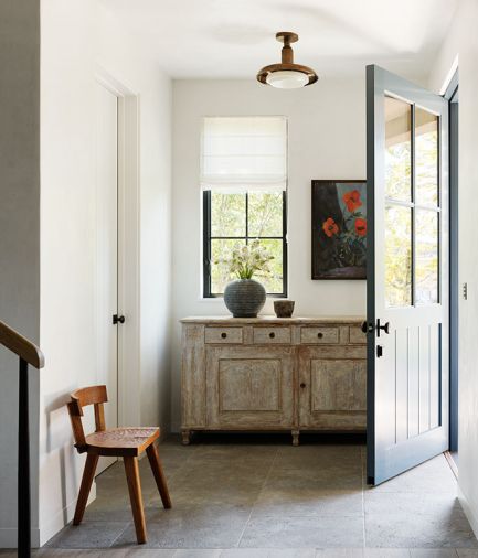 From the moment you step into the home upon aged limestone tile, simplicity reigns. An antique sideboard ties to a rare Artisans of Moralles 1950s cooperative handcrafted chair.