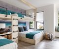 Children delight in the unique whitewashed rustic alder bunkbed configuration with sturdy custom mounting hardware. The Wolf Gordon watercolor wallcovering acts as a soft reminder of the Camano Island skyline. Window seat with leather pull drawer mimics the built-in dresser.