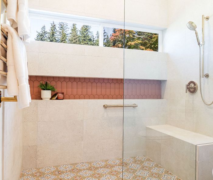 An expansive, curbless, walk-in shower now facilitates easy aging-in-place, select finishes like the Wayfair Merola Tile on the floor and Terracotta tile from CFM in the linear storage niche, both a nod to the client’s Spanish heritage. A towel warmer and shower fittings are the finishing touch.