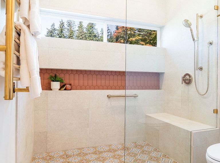 An expansive, curbless, walk-in shower now facilitates easy aging-in-place, select finishes like the Wayfair Merola Tile on the floor and Terracotta tile from CFM in the linear storage niche, both a nod to the client’s Spanish heritage. A towel warmer and shower fittings are the finishing touch.