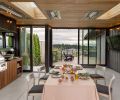 The ventilation fan over the Alfresco Grill ALXE is concealed by tile, chosen to meld with the painted cedar walls.